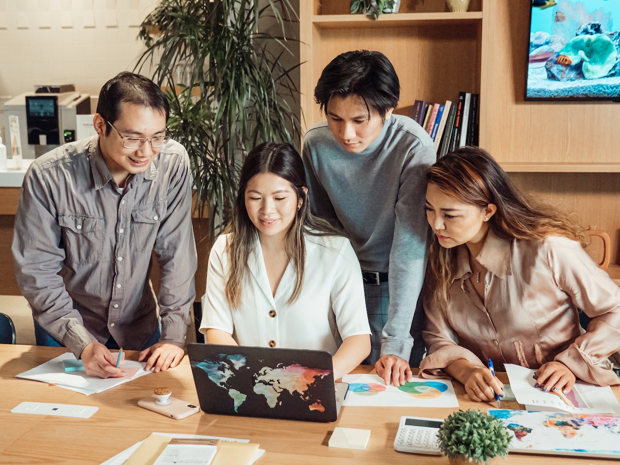 Image of office workers in Asia having a discussion with their boss