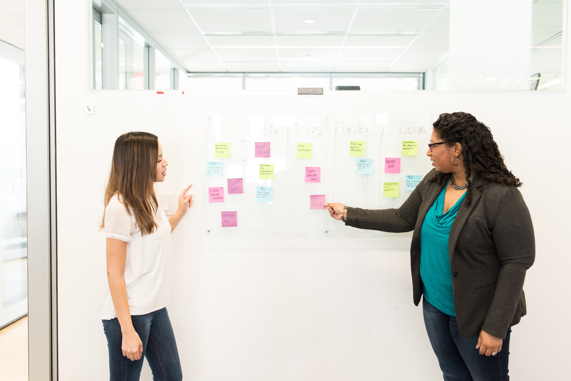 Image of two women checking their planning on sticky notes