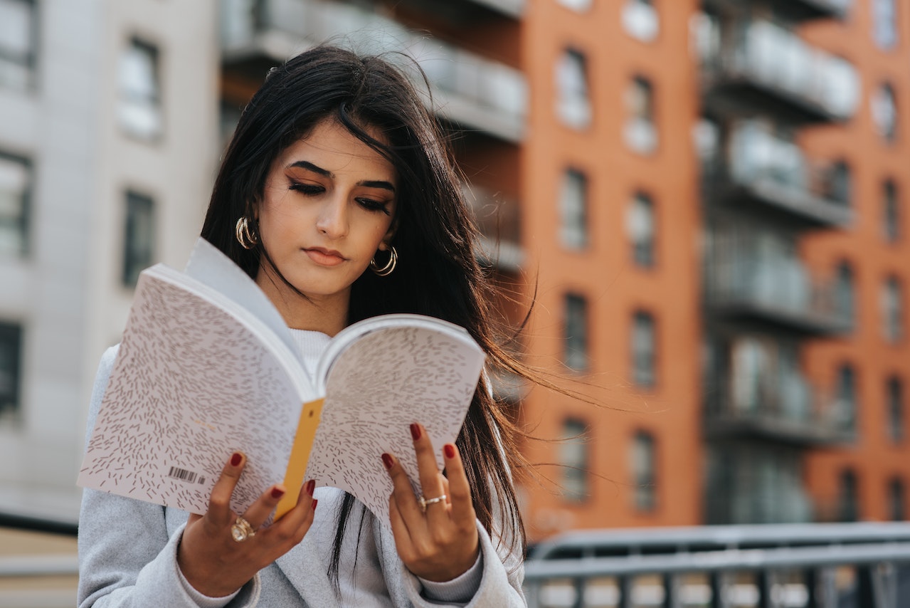 Picture of a woman reading a book outdoors